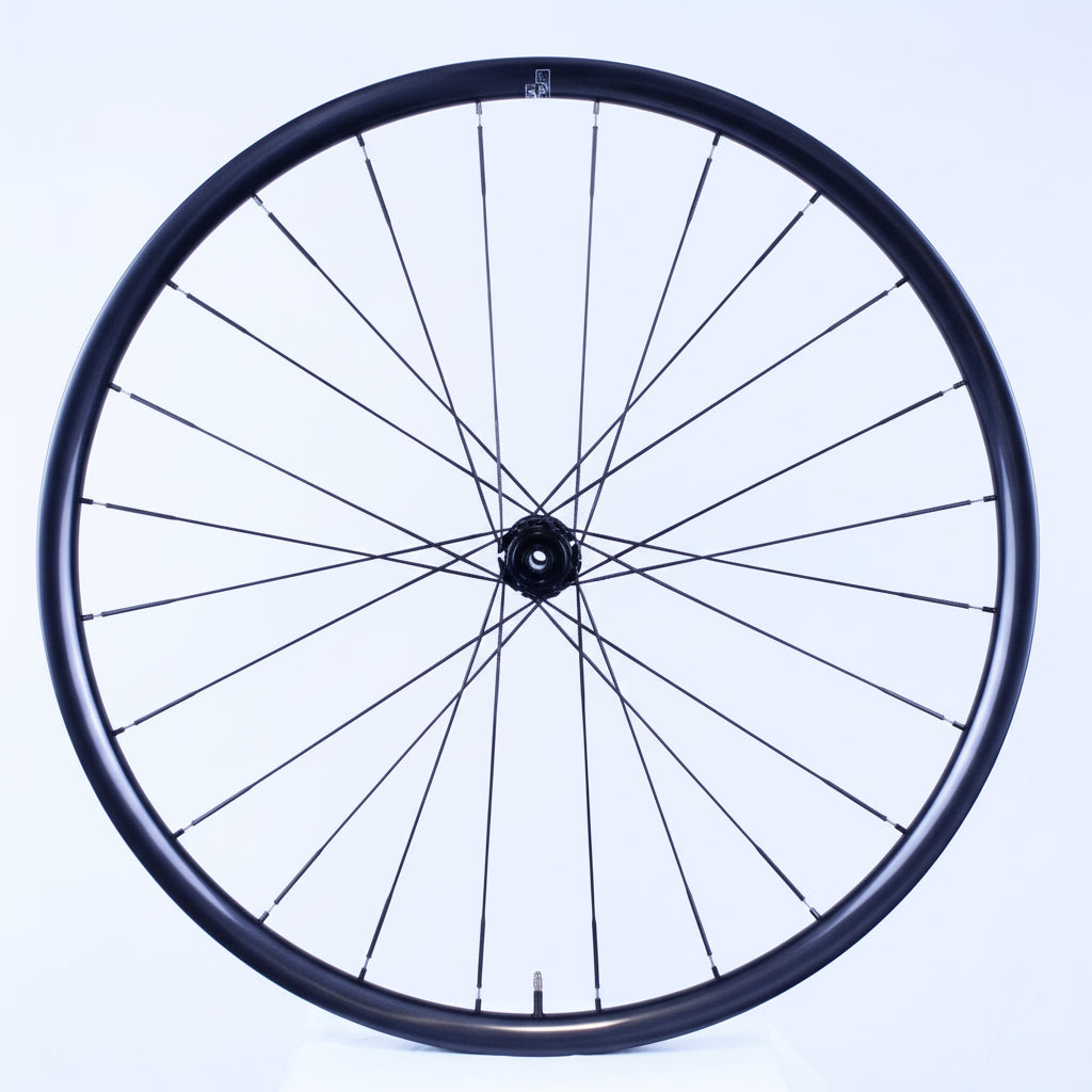 Bicycle wheel with black rim and spokes on a white background