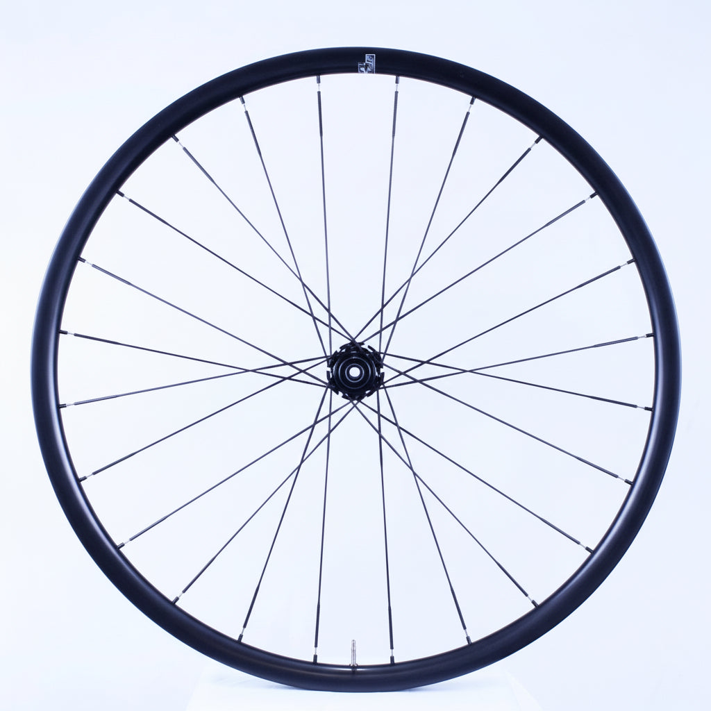 Bicycle wheel with black rim and spokes on a white background